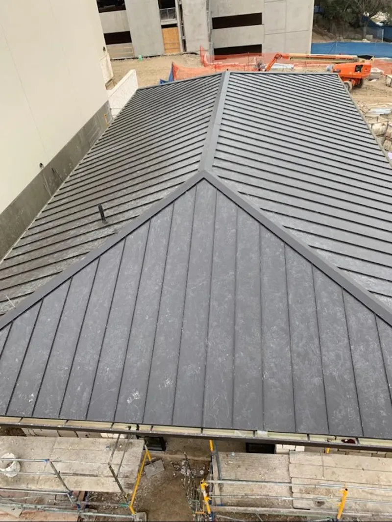 Commercial metal roof construction with crane equipment in Smiths Station